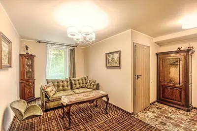 a living room with a couch and a table at Vilhelmhaus in Dėdeliškės