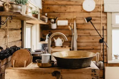 a kitchen with a sink and a bowl on a table at Vienkiemio Oazė - Namelis Prie Upelio in Galvokai