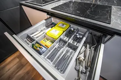 an open drawer in a kitchen with utensils at Botanical Garden Loft in Kaunas