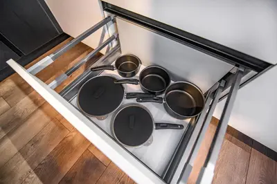 a stove top with four pots and pans on it at Botanical Garden Loft in Kaunas