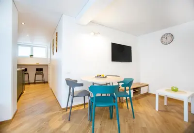 a kitchen and dining room with a table and chairs at Groundfloor Apartment on the Green Hill in Kaunas