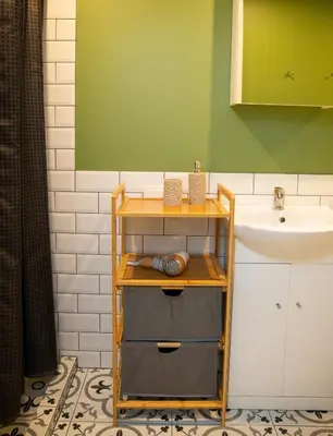 a bathroom with a sink and a shelf next to a sink at Groundfloor Apartment on the Green Hill in Kaunas