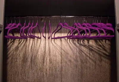 a bunch of purple toothbrushes are on a rack at Siauliai Apartments - Lieporiu in Šiauliai