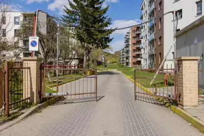 an empty street with a gate and some buildings at Close to PANORAMA center apartment Self check-in Garage free in Vilnius