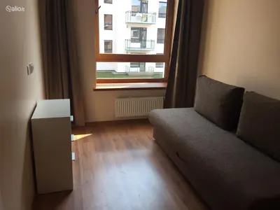a living room with a couch and a window at Close to PANORAMA center apartment Self check-in Garage free in Vilnius