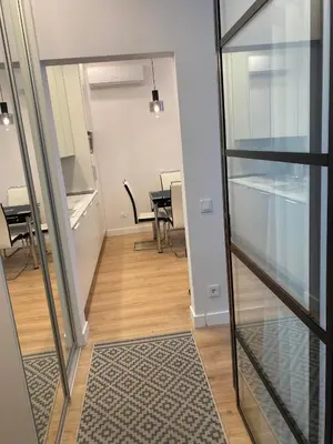 a hallway with a table and chairs in a building at Moder Chic Apartment in Center-PRIME RENTALS in Kaunas