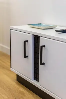 a white table with a plate on top of it at Moder Chic Apartment in Center-PRIME RENTALS in Kaunas