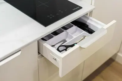 a drawer in a white kitchen with a knife and scissors at Moder Chic Apartment in Center-PRIME RENTALS in Kaunas