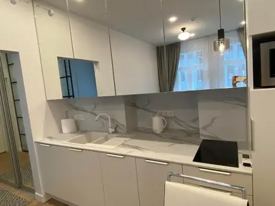 a kitchen with white cabinets and a sink at Moder Chic Apartment in Center-PRIME RENTALS in Kaunas