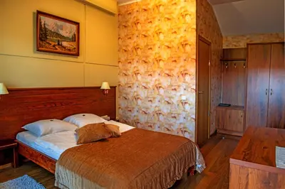 a bedroom with a bed in a room with yellow walls at Motelis SMAKŲ SMAKAS in Šiauliai