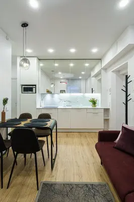 a kitchen and living room with a table and chairs at Modern Rustic in Center-PRIME RENTALS in Kaunas