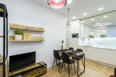 a kitchen and dining room with a table and chairs at Modern Rustic in Center-PRIME RENTALS in Kaunas
