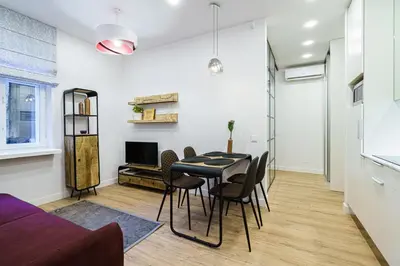 a living room with a table and chairs and a couch at Modern Rustic in Center-PRIME RENTALS in Kaunas