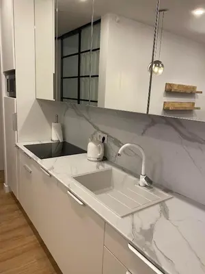 a white kitchen with a sink and a counter at Modern Rustic in Center-PRIME RENTALS in Kaunas