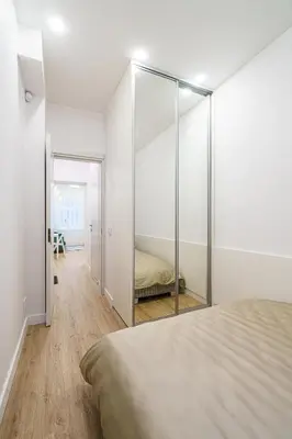 a bedroom with a mirror and a bed at Modern Scandinavian Feeling-PRIME RENTALS in Kaunas