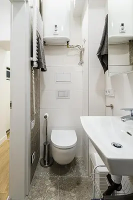 a white bathroom with a toilet and a sink at Modern Scandinavian Feeling-PRIME RENTALS in Kaunas