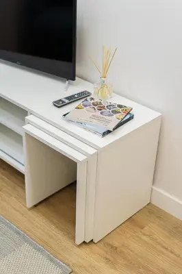 a white table with a tv on top of it at Modern Scandinavian Feeling-PRIME RENTALS in Kaunas
