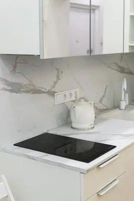 a white kitchen with a toaster on a counter at Modern Scandinavian Feeling-PRIME RENTALS in Kaunas