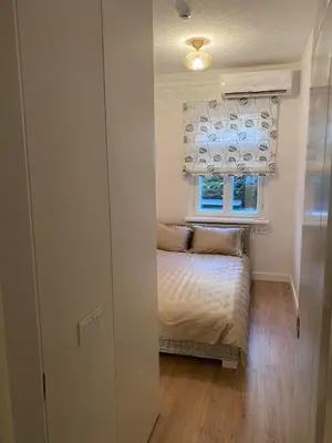 a small bedroom with a bed and a window at Modern Scandinavian Feeling-PRIME RENTALS in Kaunas