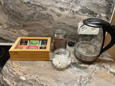 a counter top with a coffee maker and a tea kettle at E.M. Studio In City Center in Kaunas