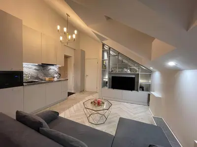 a living room with a couch and a table at E.M. Studio In City Center in Kaunas