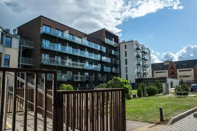 an apartment building with a fence in front of it at E.M. Studio In City Center in Kaunas