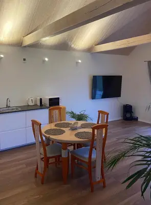 a kitchen and dining room with a table and chairs at Mandarinas in Anykščiai