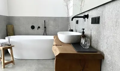 a bathroom with a large tub and a sink at Villa The Lake in Mindūnai