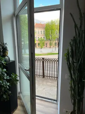 a sliding glass door with a view of a building at Happy Kaunas in Kaunas