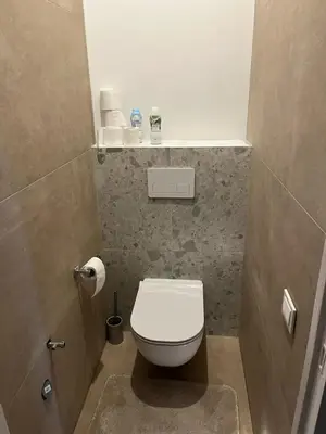 a bathroom with a white toilet in a stall at Happy Kaunas in Kaunas
