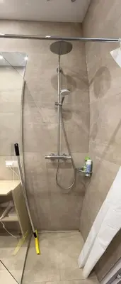 a shower with a glass door in a bathroom at Happy Kaunas in Kaunas