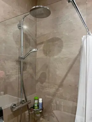 a shower with a glass door in a bathroom at Happy Kaunas in Kaunas