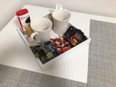 a white table with two cups and snacks on it at Happy Kaunas in Kaunas