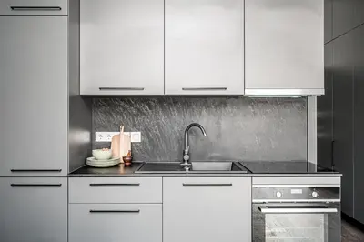 a kitchen with white cabinets and a sink at Vilnius Old-Town Renaissance Studios in Vilnius