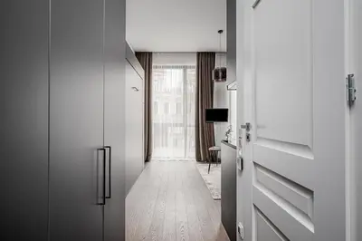 a hallway with white cabinets and a hallway with a hallwayngth at Vilnius Old-Town Renaissance Studios in Vilnius