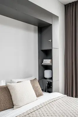a bedroom with a bed with a black headboard at Vilnius Old-Town Renaissance Studios in Vilnius