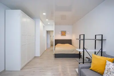 a small bedroom with a bed and a couch at Kepezinski Centre Apartments in Kaunas