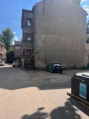 a car parked in a parking lot next to a building at Kepezinski Centre Apartments in Kaunas
