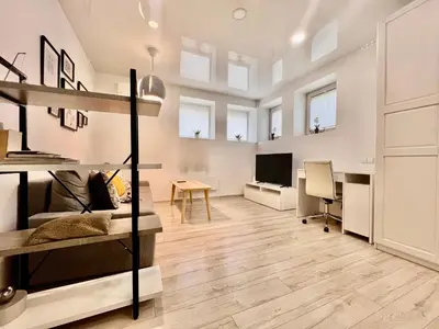 a living room with a couch and a television at Kepezinski Centre Apartments in Kaunas