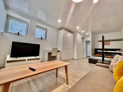 a living room with a flat screen tv and a coffee table at Kepezinski Centre Apartments in Kaunas