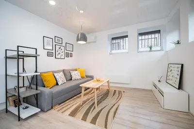 a living room with a couch and a table at Kepezinski Centre Apartments in Kaunas