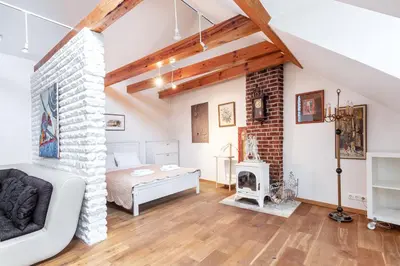 a living room with a bed and a fireplace at Castle View Apartment by Reside Baltic in Vilnius