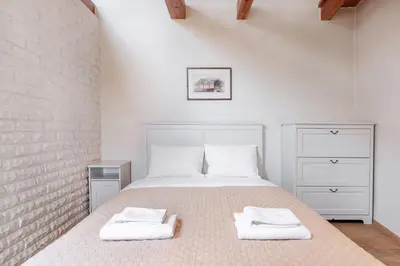 a bedroom with a bed with two towels on it at Castle View Apartment by Reside Baltic in Vilnius