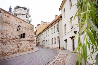 an empty street in an old city with buildings at Castle View Apartment by Reside Baltic in Vilnius