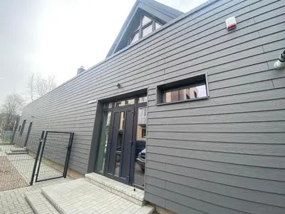 a building with a door and a window on it at Kamurke - Apartamentai in Šiauliai