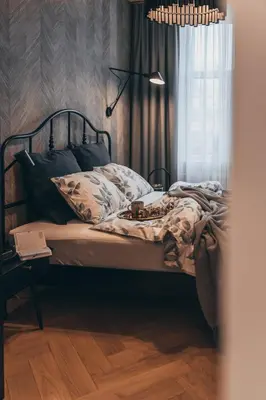 a bedroom with a bed and a window at Lindens apartments with AC and view to central square in Panevėžys