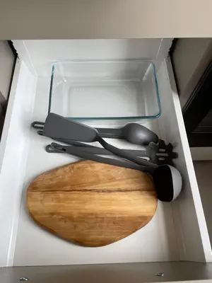 a cutting board and utensils in a drawer at Lindens apartments with AC and view to central square in Panevėžys