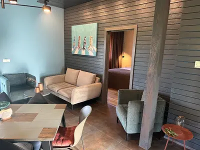 a living room with a couch and a table at MĖTA in Birštonas