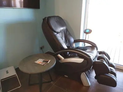 a leather chair and a table in a room at MĖTA in Birštonas