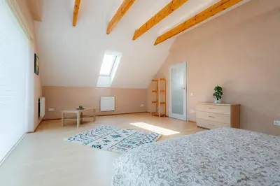 a bedroom with a bed and a dresser in a room at Jaukus svečių namelis in Druskininkai